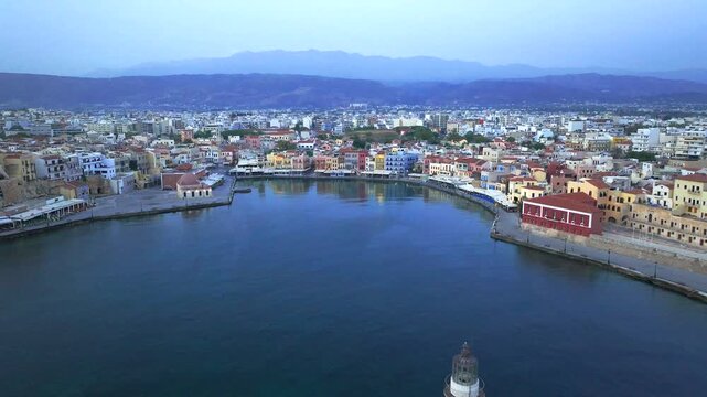  View of Chania with the amazing lighthouse, mosque, venetian shipyards, Crete, Greece.Waves crashing on lighthouse, Beautiful Greece and best scenic places - panorama