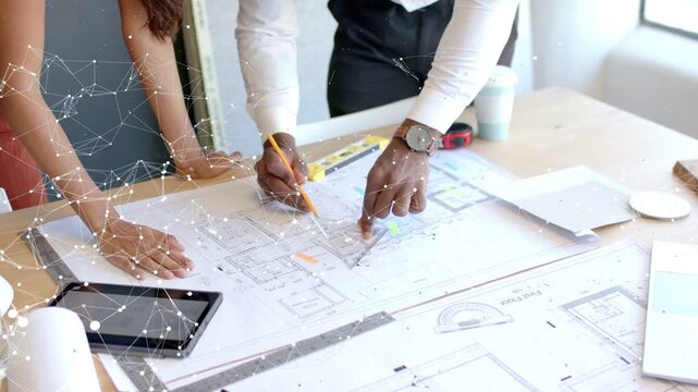 Woman pointing, designer marking plans, overlay tracing pencil and flagging areas for design review