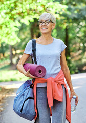 Obraz premium Portrait of a happy active senior woman posing after exercising outdoors, healthy lifestyle and vitality concepts