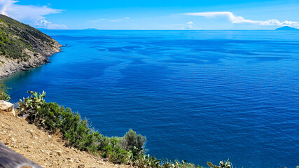 Fototapeta premium Scenic coastal landscape of Elba Island with turquoise water and green slopes.