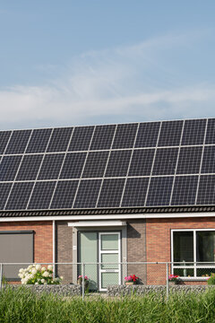 Breskens, Netherlands. Residential house with solar panels and garden illustrating sustainable living and decentralized energy production