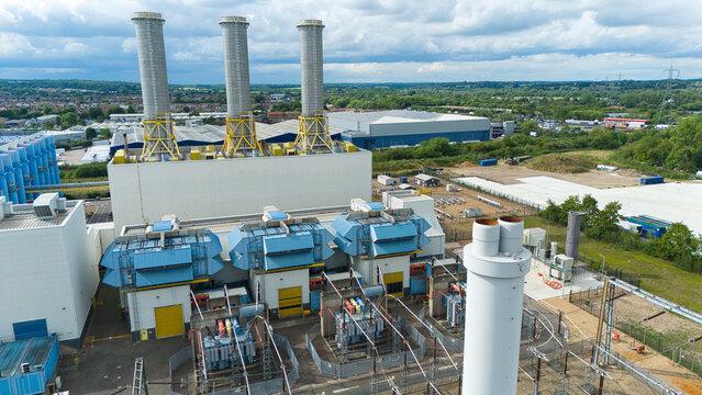 Aerial view of Rye House Power Station with its three tall chimneys and industrial equipment in Hoddesdon, England, United Kingdom.