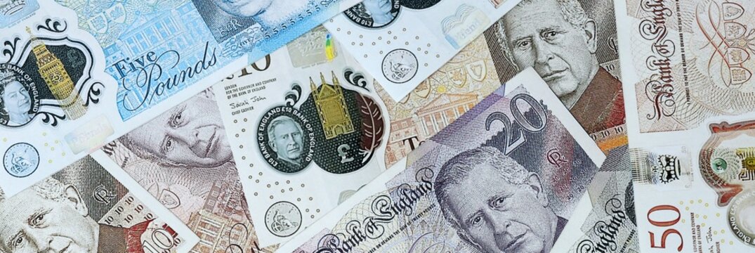 British pound money bills in pile on table. United Kingdom GBP currency cash