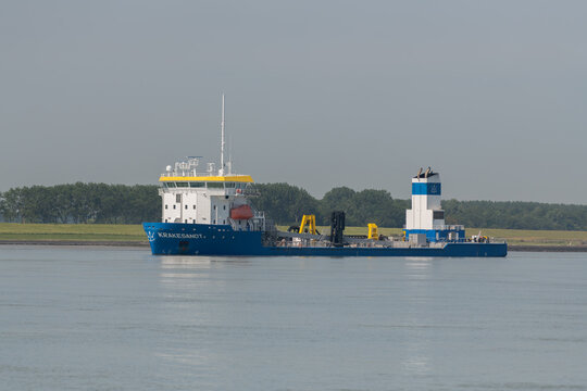 21 June 2026, Breskens, Netherlands. Trailing suction hopper dredger Krakesandt sailing on the Westerschelde estuary for coastal engineering and sediment management