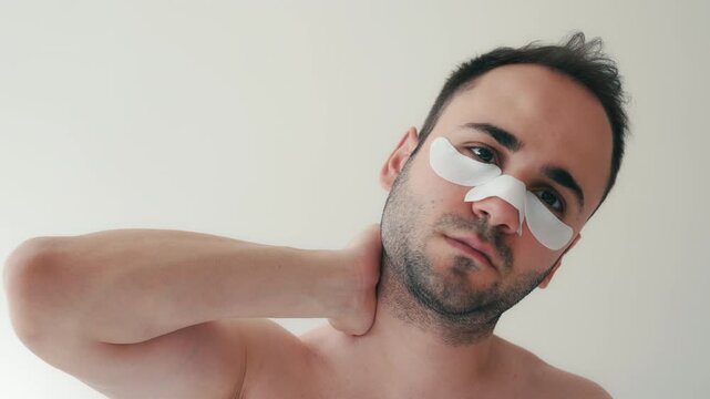 Close-up of young person applying under eye patches and nose strip