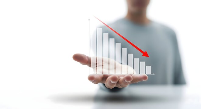 Man holding a transparent bar chart displaying a downward trend and a red arrow against a white background.