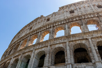 Obraz premium Famous tourist attraction of historic Colosseum amphitheatre with ancient stone arches in Rome Italy
