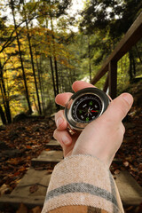 Obraz premium Tourist using compass to find way outdoors, closeup