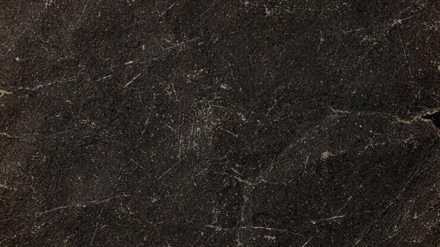 Abstract dark brown and black textured stone surface background.
