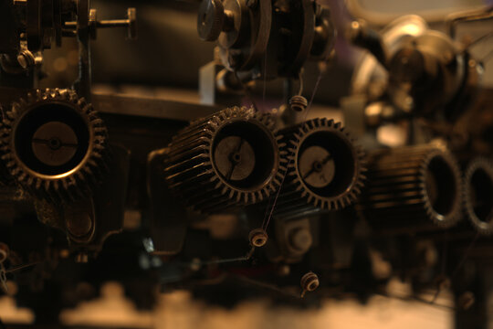 Screws and metal gears of a textile machine, detailed view