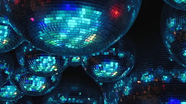 Overhead, numerous mirror balls cast dazzling, shifting patterns of red, green, and blue light across a lively club space during an electrifying evening celebration. The atmosphere is truly enchanting