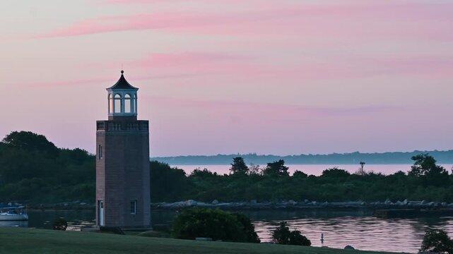 Groton, Connecticut, USA - Avery Point Lighthouse And Sailboat At Sunrise