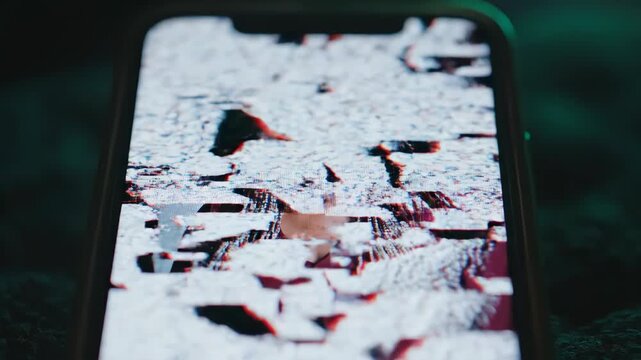 Smartphone screen with digital glitch and distortion. Scary supernatural transformation of a woman's face into a screaming monster. Horror jump scare concept
