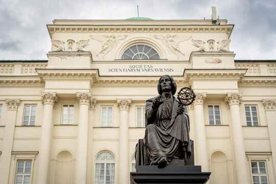 Copernicus statue in Warsaw with armillary sphere before neoclassical facade and grand columns pride
