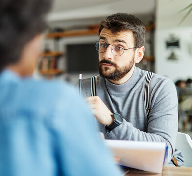 Portrait of young businesswoman and businessman during a meeting or job interview in front of members of the management in the office