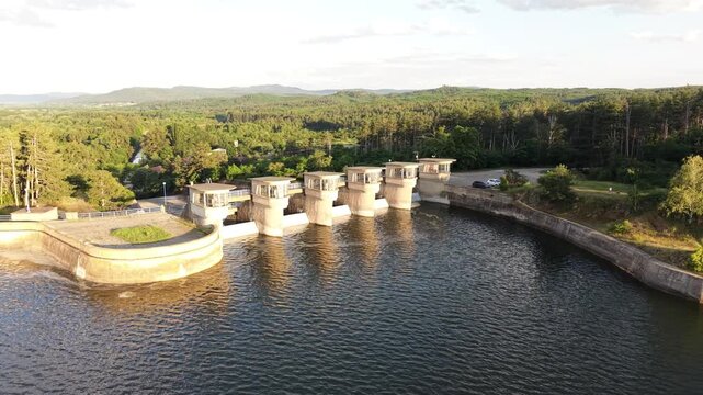 Aerial Drone Shot of Reservoir Dam Structure and Control Gates at Sunset