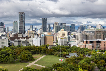 Obraz premium Viewing business district with contemporary architecture and layered cityscape in daylight, Osaka, Japan