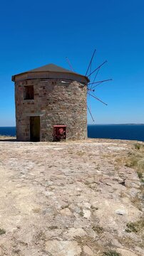 old windmill on the island of crete. Windmill on the hill. 4k video. Bozcaada, Turkey.