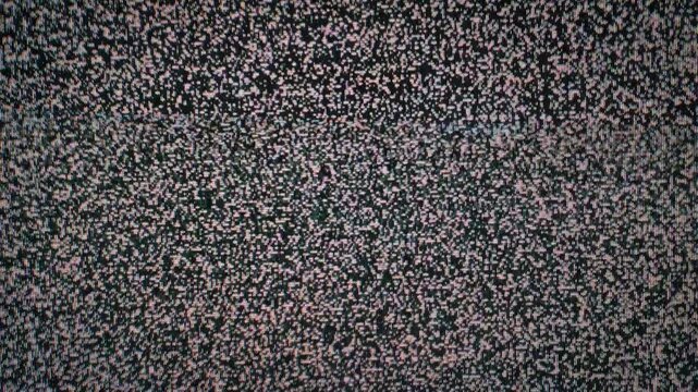 Close-up of classic analog television static displaying a dense pattern of flickering black and white dots. The noise represents a lack of signal or broadcast interference.