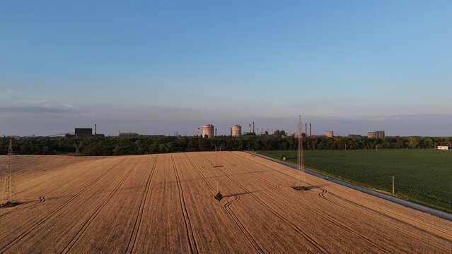 Drone view of harvested wheat fields at sunset near Baracs