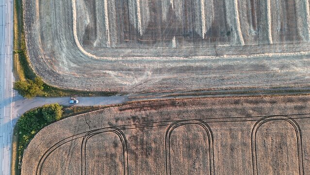 Drone view of harvested wheat fields at sunset near Baracs