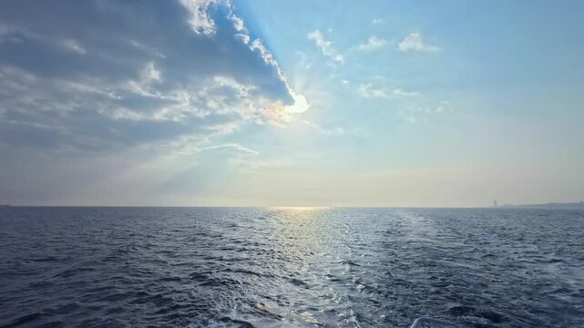 Stunning maritime footage with powerful sunbeams bursting through moving clouds