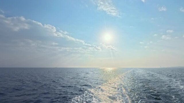 Stunning morning seascape from a vessel's perspective featuring white foam and scenic sky