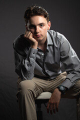 Fototapeta premium young man sitting on a chair