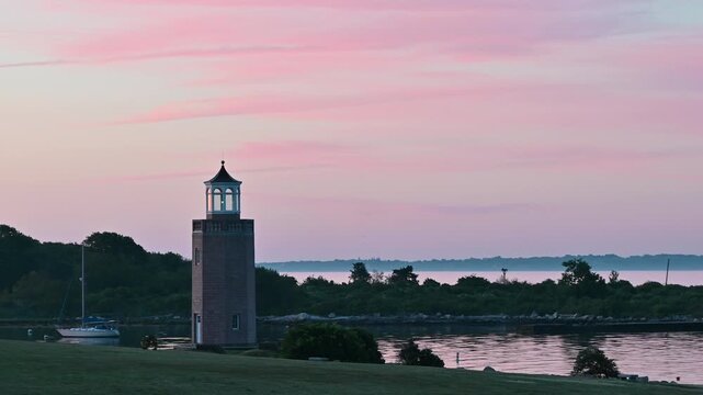 Groton, Connecticut, USA - Avery Point Lighthouse And Sailboat At Sunrise