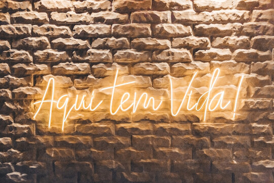 Warm Neon Sign on an Exposed Brick Wall