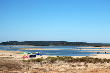 Fototapeta premium Beach in Sines alongisde the Avenida Marginal - the coastal road - widely used for walking or jogging, and surrounded by bars and terraces, the beach is the scene of sporting events and concerts