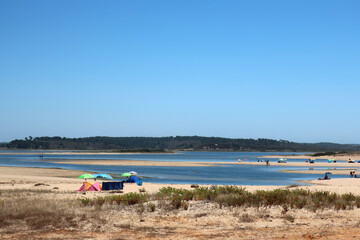 Fototapeta premium Beach in Sines alongisde the Avenida Marginal - the coastal road - widely used for walking or jogging, and surrounded by bars and terraces, the beach is the scene of sporting events and concerts