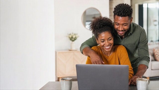 Happy African American Couple Using Laptop Together at Home