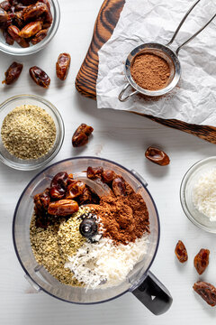 A food processor filled with ingredients for making energy balls.