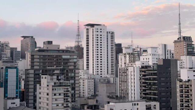 SAO PAULO, BRAZIL - JUNE 11, 2026: Time lapse sunset view of Casper Libero Tower and Paulista skyline lighting up at night