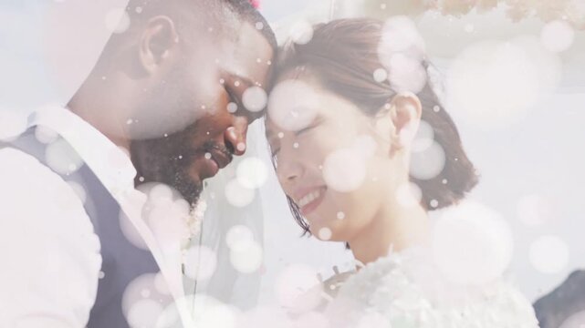 Wedding couple leaning together as bokeh overlay thinning, revealing veil bouquet, sharing intimacy