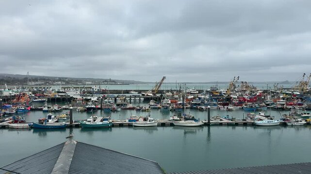 Newlyn Cornish fishing village in England with boats in the harbour scenic area for vacation and holiday but once a port for the fish industry UK 4K