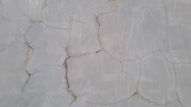 Cracked exterior house wall with mold, grass, and exposed white brick. Damaged plaster texture outdoor. Building deterioration stock video 4K for inspection, construction, repair, maintenance, real es