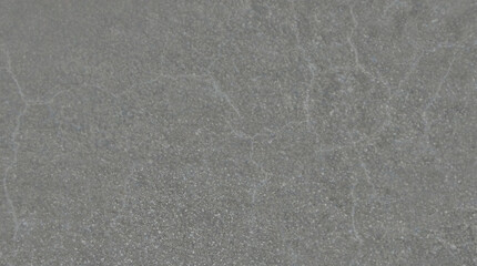 Fototapeta premium Industrial gray concrete texture with subtle cracks, weathered cement wall background, minimalist stone surface for architectural design and overlays