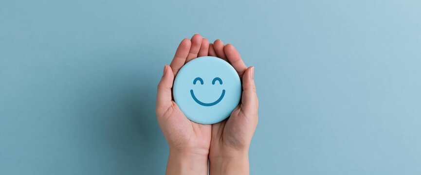 Hands holding a blue circle with a happy smiling face for positive customer feedback