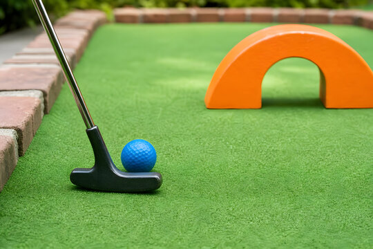 Putter and Ball on Mini Golf Course Obstacle