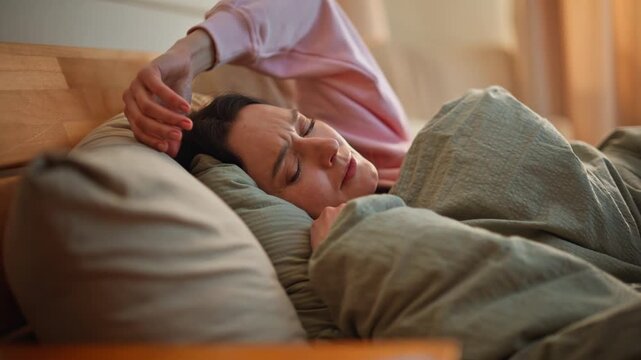 Closeup lady waking up in bed reaching smartphone checking time. Sleepy brunette