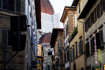 Fototapeta premium The Duomo of the Cattedrale di Santa Maria del Fiore Seen From a Narrow Street, Florence, Italy