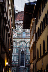 Fototapeta premium The Duomo of the Cattedrale di Santa Maria del Fiore Seen From a Narrow Street, Florence, Italy