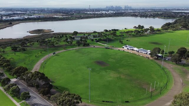 Aerial view of australian football ground with melbourne skyline