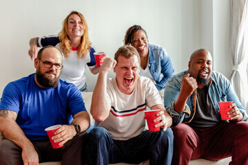 Fototapeta premium Friends celebrating with red cups