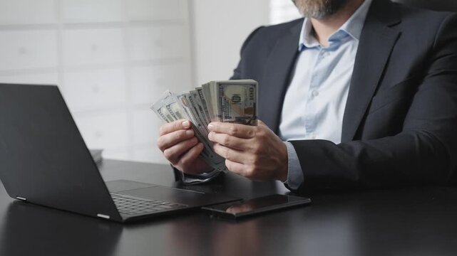Hands hold money in office. Businessman counting dollars close-up. Banker counting money. Office scene with hands count money. Counting cash close up. Finance expert.