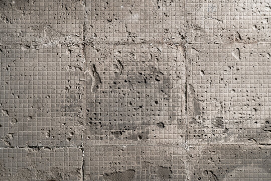 Brutalism rough floor texture with grid pattern from removed tile