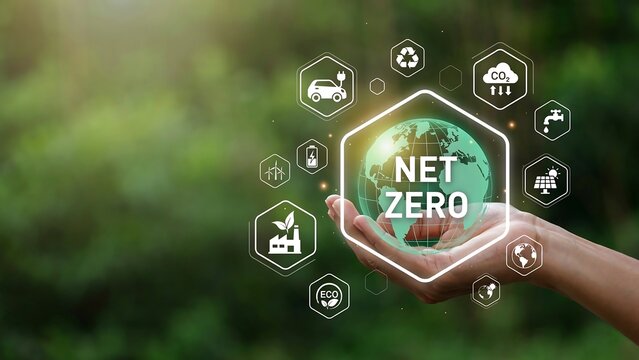 A hand holds a glowing green Earth with NET ZERO icons floating around it in a lush forest.