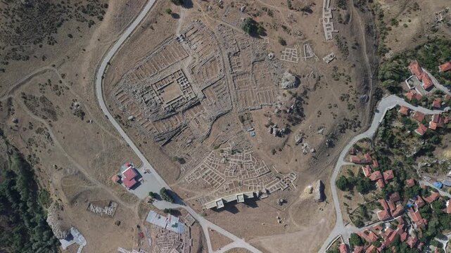 4K 10-bit top-down drone reveal shot ascending vertically to show the ancient Hittite ruins of Hattusha in Turkey